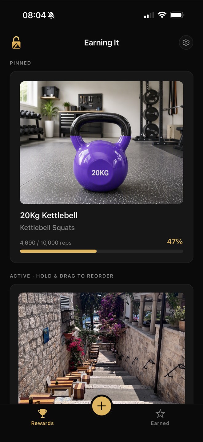 Earning It home screen: a pinned 20kg kettlebell reward at 4,690 of 10,000 squats — 47% earned